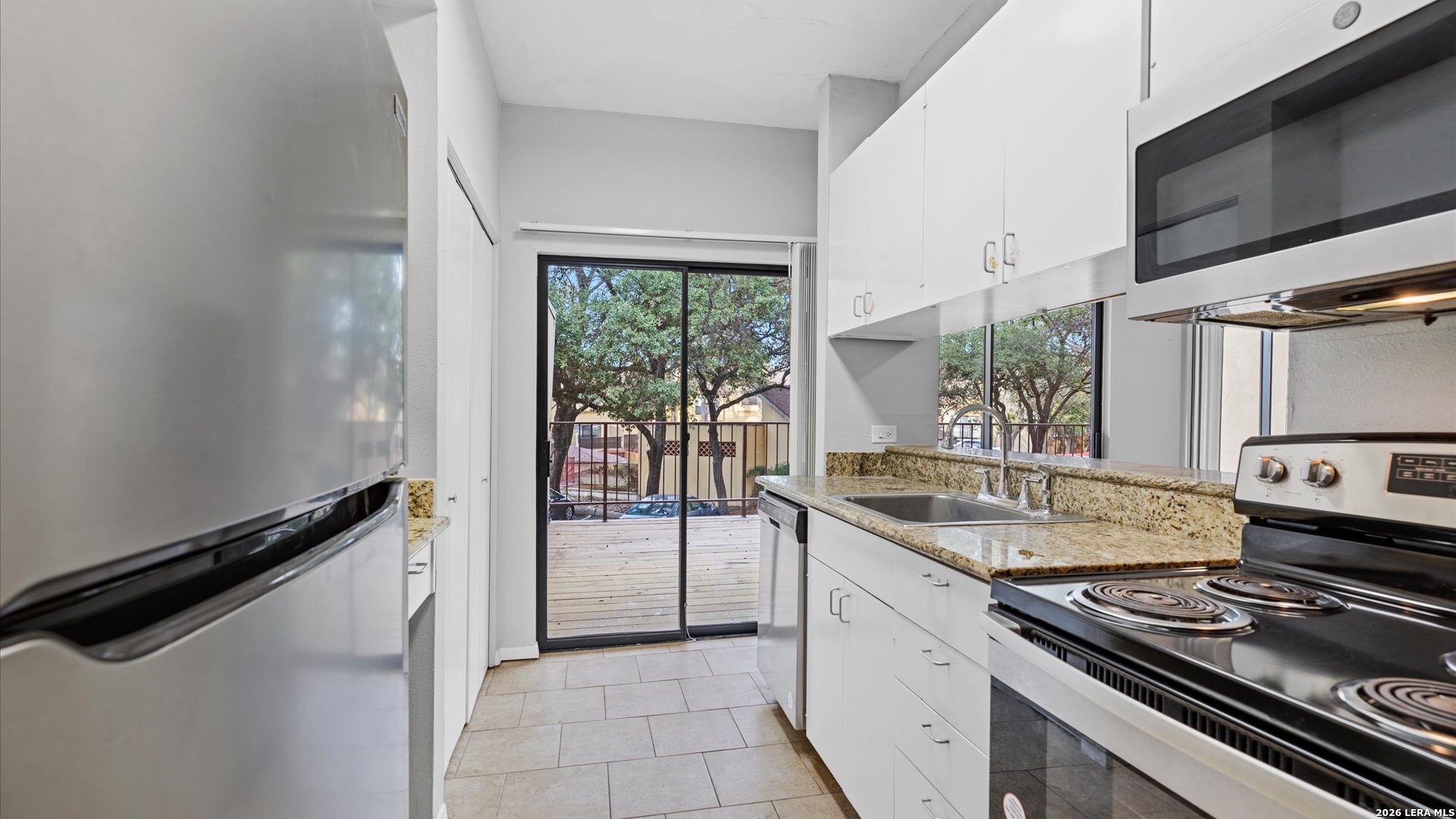 8642 Fredericksburg Road, Unit 405 San Antonio, TX 78240 - Photo 6 of 24 a kitchen with a stove and a sink