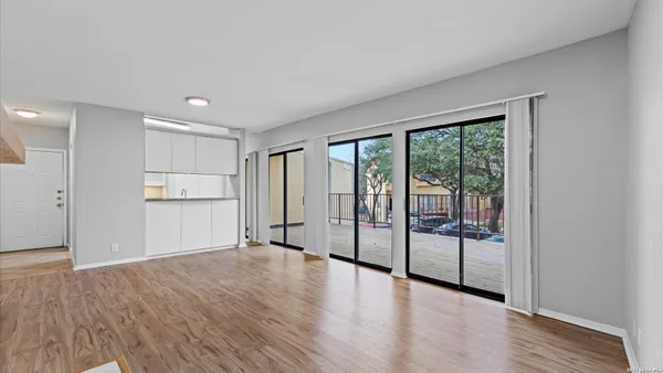 a view of empty room with wooden floor