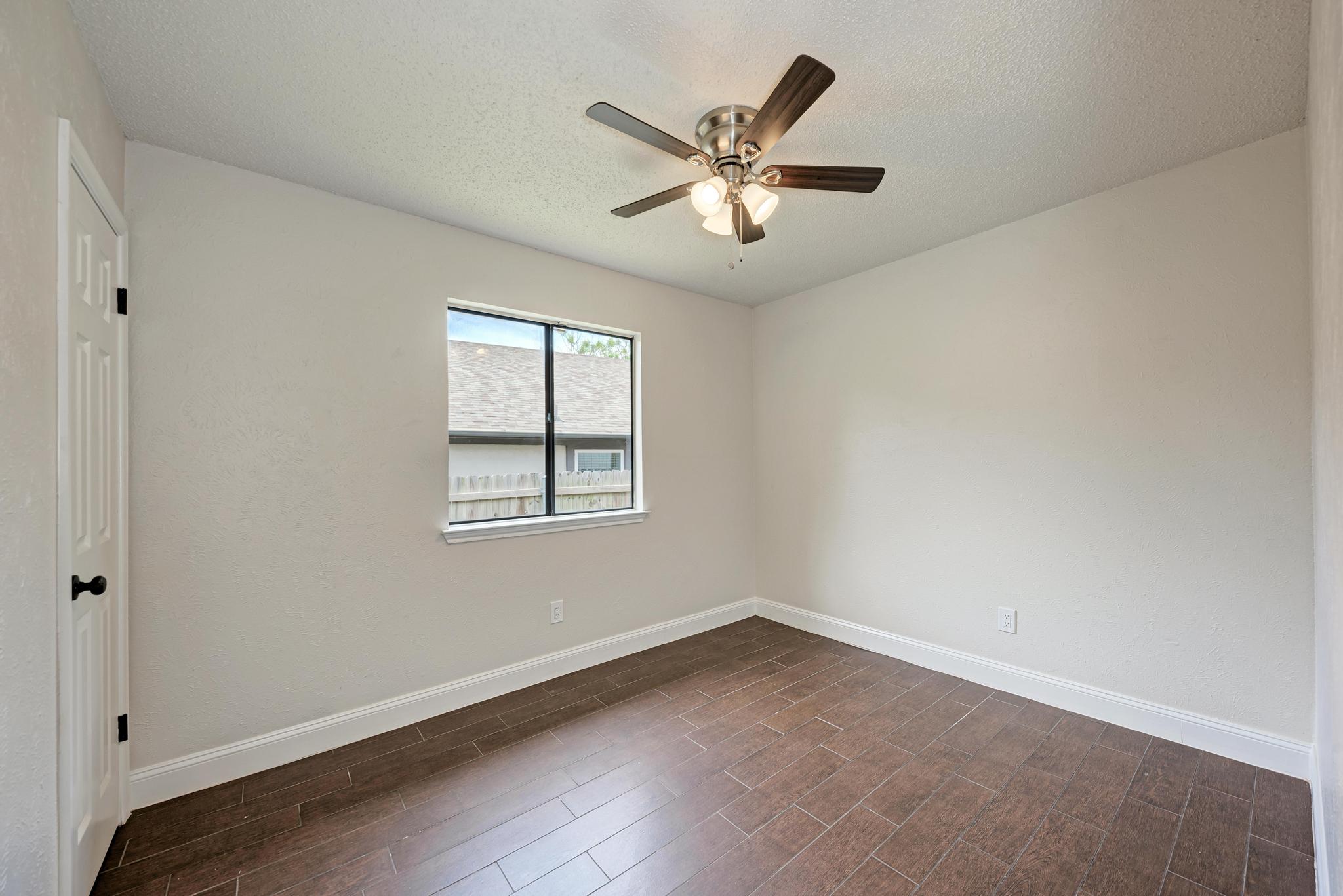 12108 Carnforth Drive Austin, TX 78753 - Photo 26 of 33 wooden floor in an empty room with a window