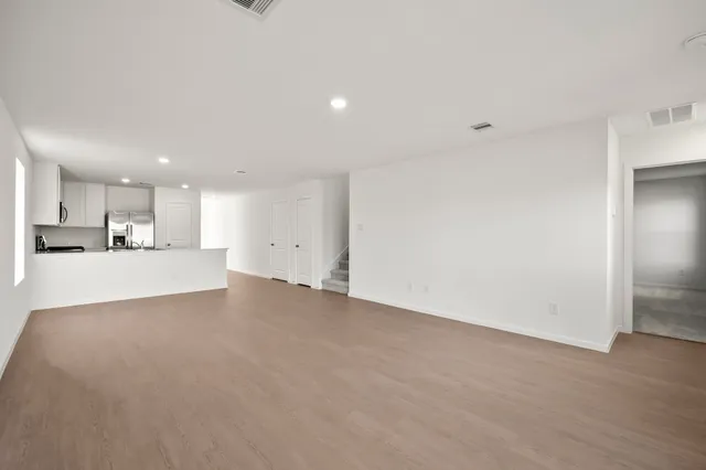 a kitchen with stainless steel appliances kitchen island granite countertop a refrigerator and a stove