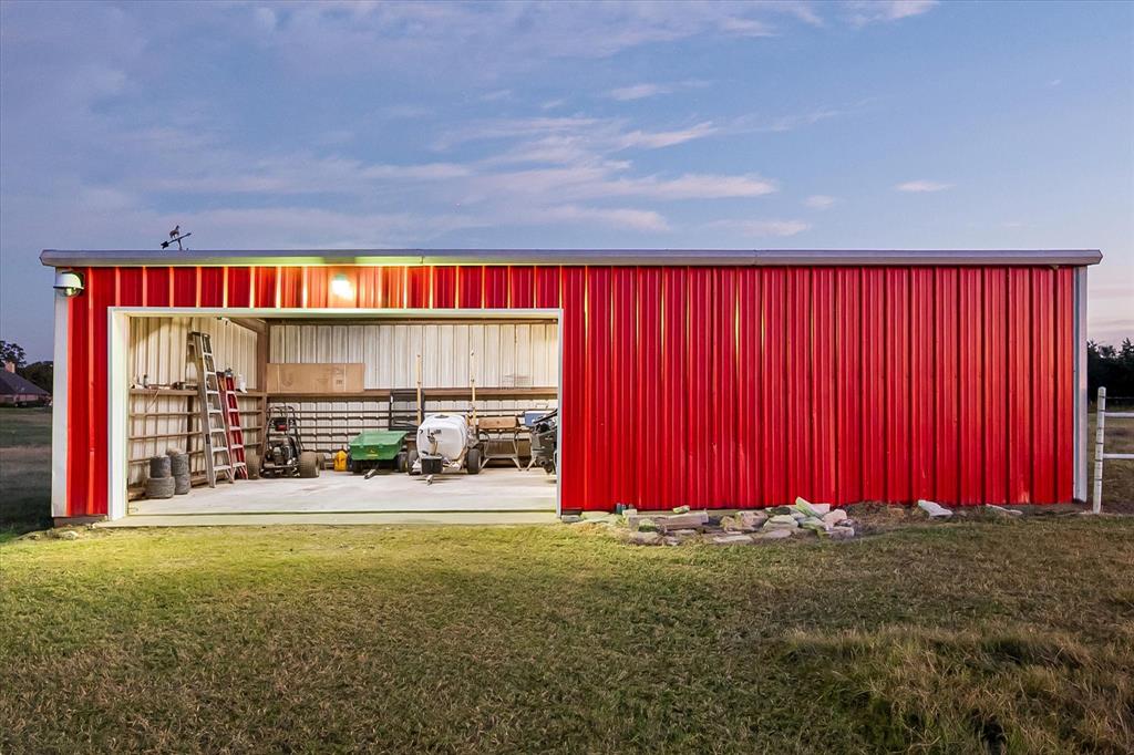 1209 Southwest County Road Corsicana, TX 75109 - Photo 15 of 27 an empty room with floor to ceiling window and an outdoor kitchen