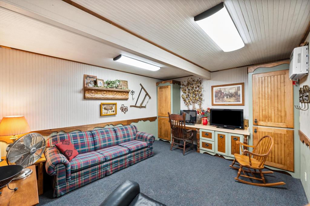 1209 Southwest County Road Corsicana, TX 75109 - Photo 7 of 27 a living room with furniture a flat screen tv and a window