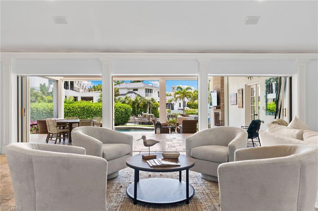 2201 Beacon Lane Naples, FL 34103 - Photo 10 of 25 a living room with furniture and a large window
