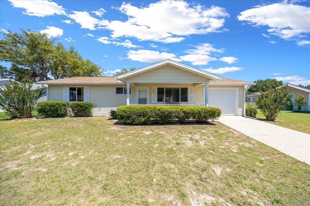 8445 Southwest 109th Street Ocala, FL 34481 - Photo 1 of 32 a front view of a house with a yard