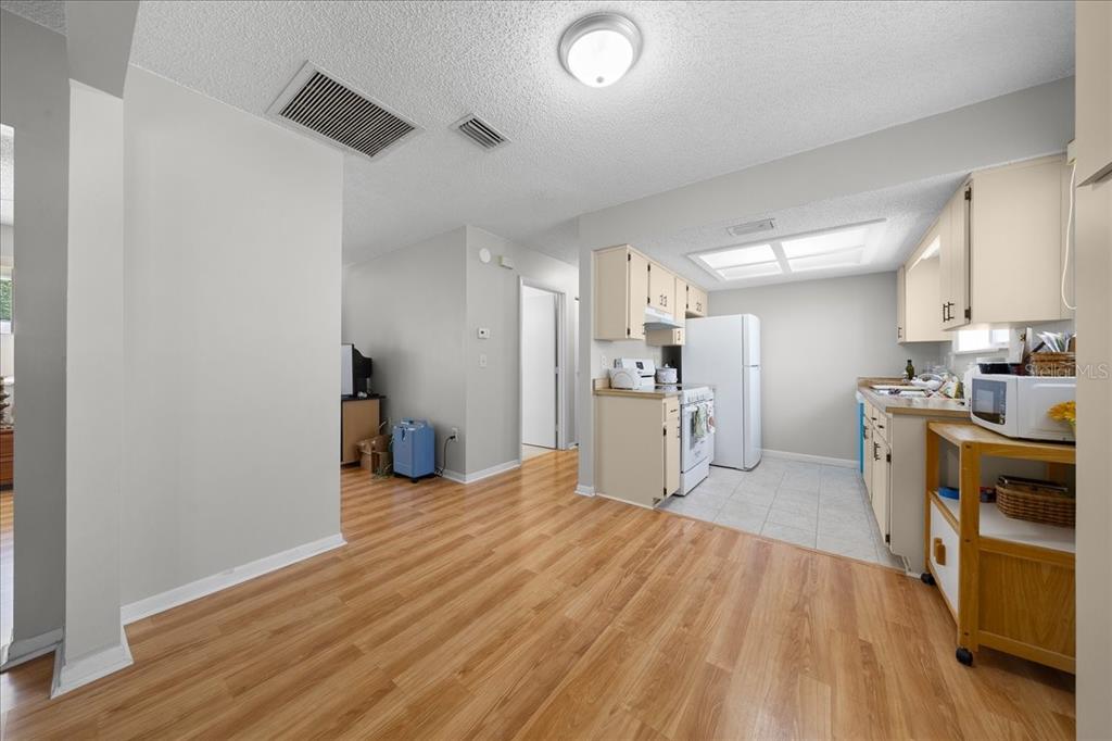 8445 Southwest 109th Street Ocala, FL 34481 - Photo 11 of 32 a view of a kitchen with furniture and wooden floor
