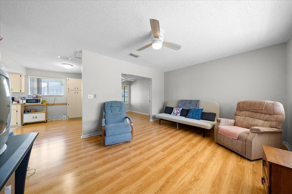 8445 Southwest 109th Street Ocala, FL 34481 - Photo 12 of 32 a living room with furniture and kitchen view