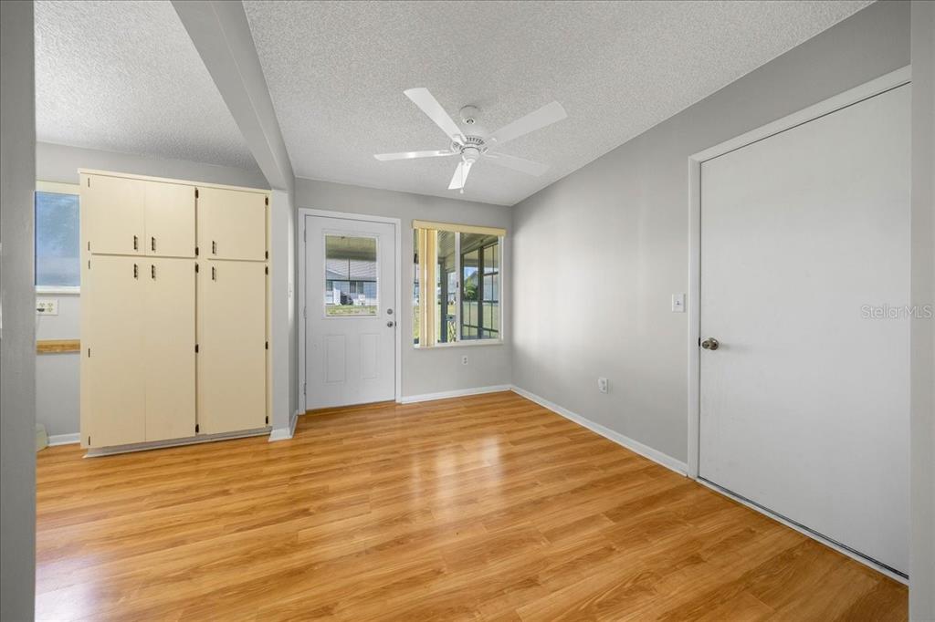 8445 Southwest 109th Street Ocala, FL 34481 - Photo 16 of 32 a view of an empty room with wooden floor and a window