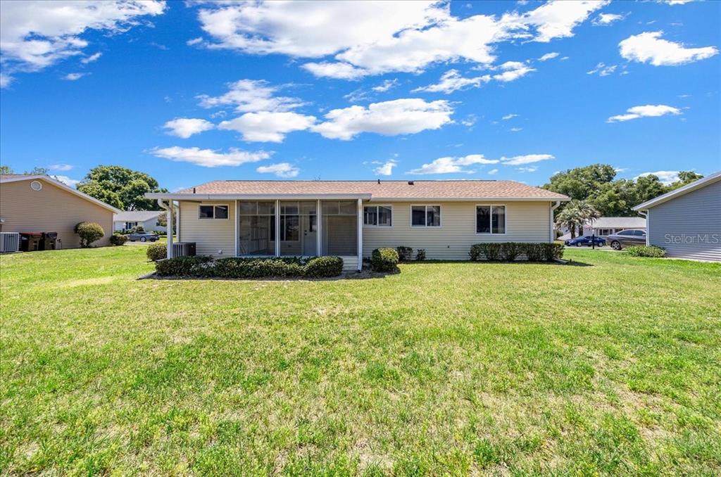8445 Southwest 109th Street Ocala, FL 34481 - Photo 20 of 32 a view of a house with a backyard