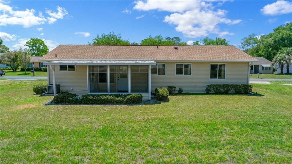 8445 Southwest 109th Street Ocala, FL 34481 - Photo 26 of 32 a front view of a house with a garden