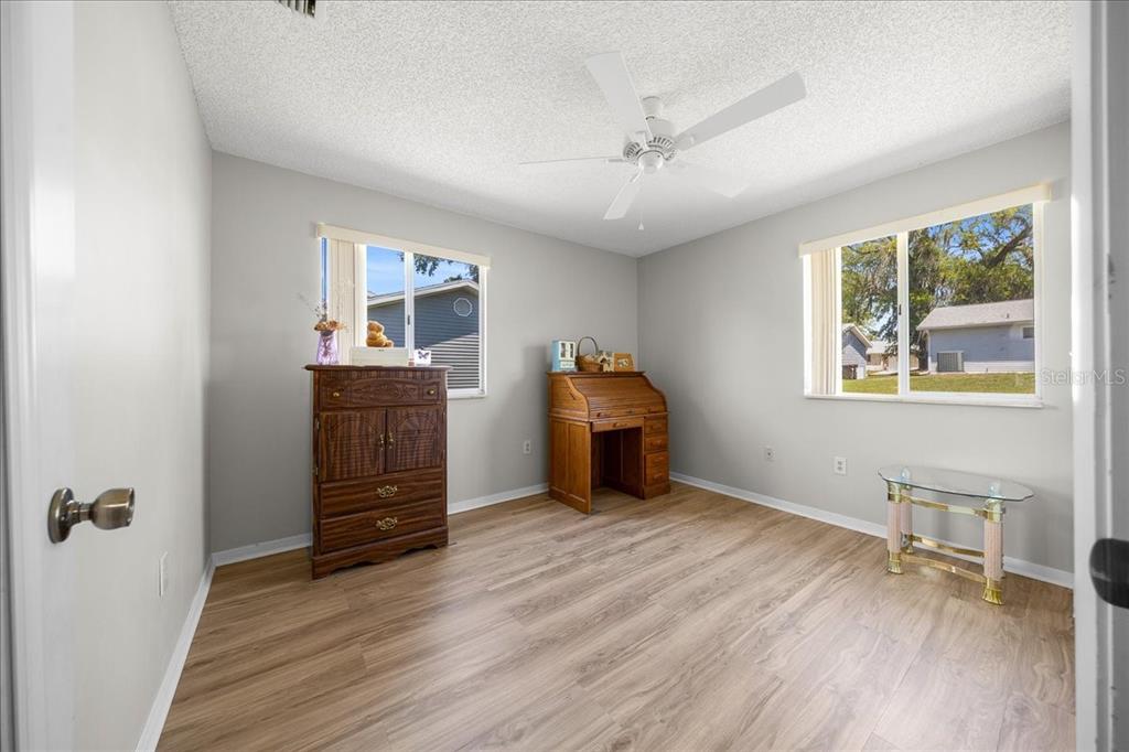 8445 Southwest 109th Street Ocala, FL 34481 - Photo 3 of 32 a view of room with window and wooden floor