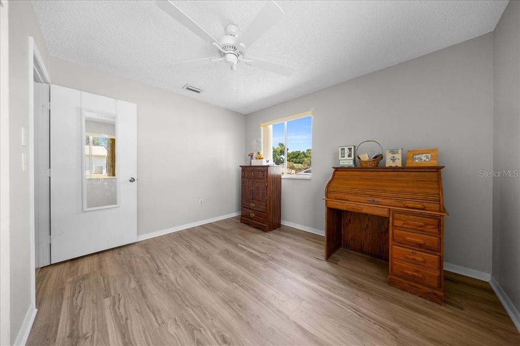 8445 Southwest 109th Street Ocala, FL 34481 - Photo 4 of 32 a room with furniture and wooden floor