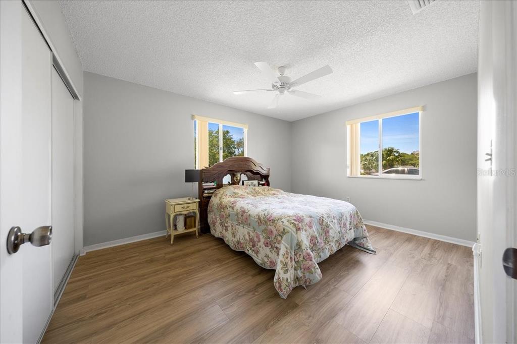 8445 Southwest 109th Street Ocala, FL 34481 - Photo 5 of 32 a bedroom with a bed and wooden floor
