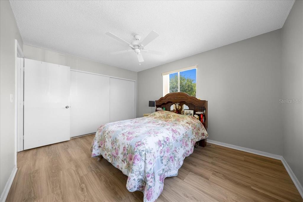 8445 Southwest 109th Street Ocala, FL 34481 - Photo 6 of 32 a bedroom with a bed and wooden floor