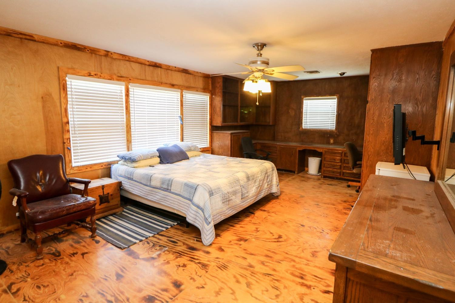 561 Farm To Market Road 302 Springlake, TX 79082 - Photo 12 of 38 a bedroom with a bed chandelier and a window