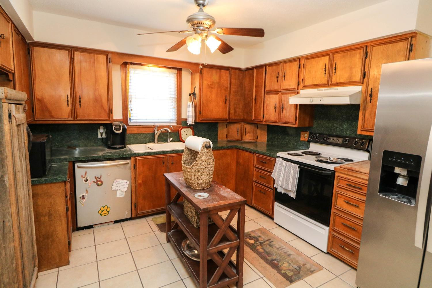 561 Farm To Market Road 302 Springlake, TX 79082 - Photo 8 of 38 a kitchen with a stove a sink and a microwave