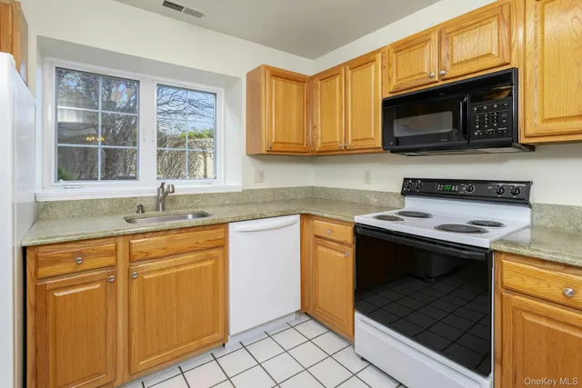 a kitchen with a sink stove and microwave