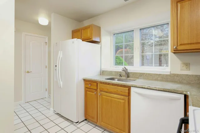 a kitchen with stainless steel appliances granite countertop a sink and a window
