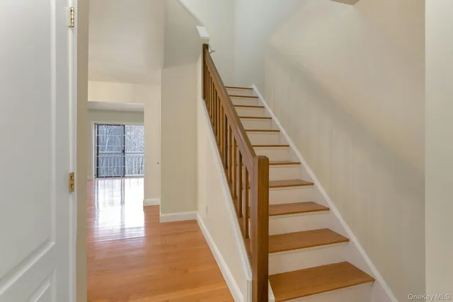 a view of a hallway with wooden floor and entryway