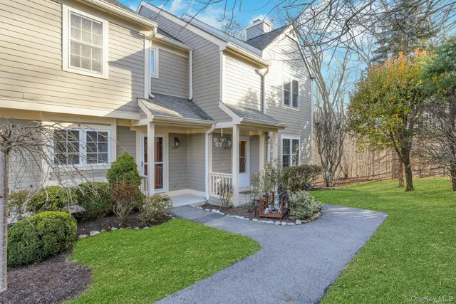 a front view of house with a garden and patio