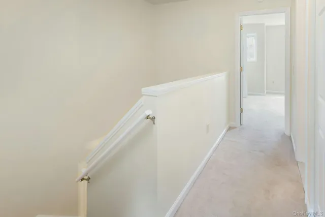 a view of a hallway with white walls