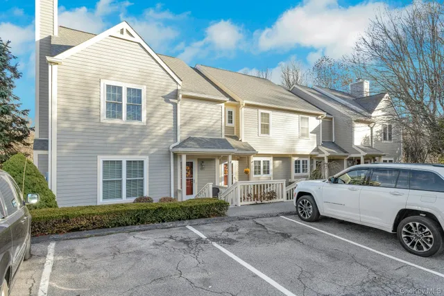 a front view of a house with a parking space