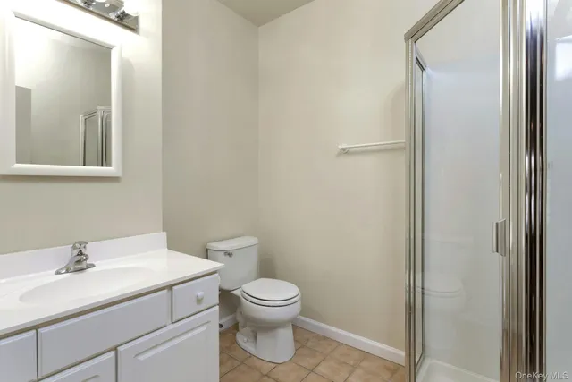 a bathroom with a toilet a sink and a mirror