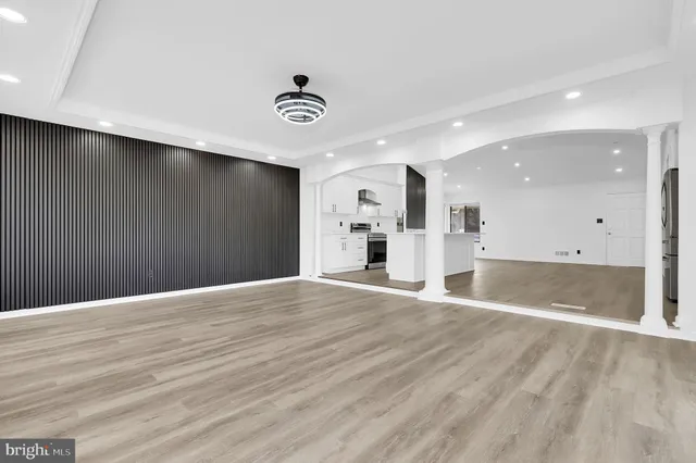 a view of an empty room with wooden floor