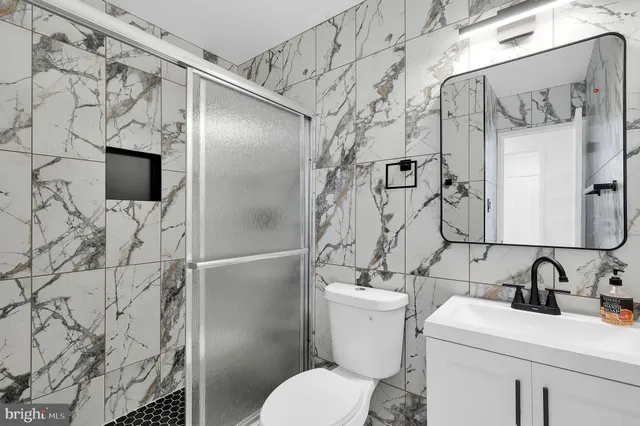 a bathroom with a sink toilet and shower