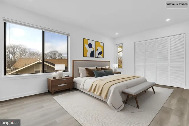 a bedroom with a bed and a large window