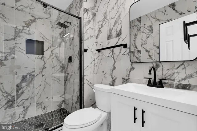 a bathroom with a sink toilet and shower