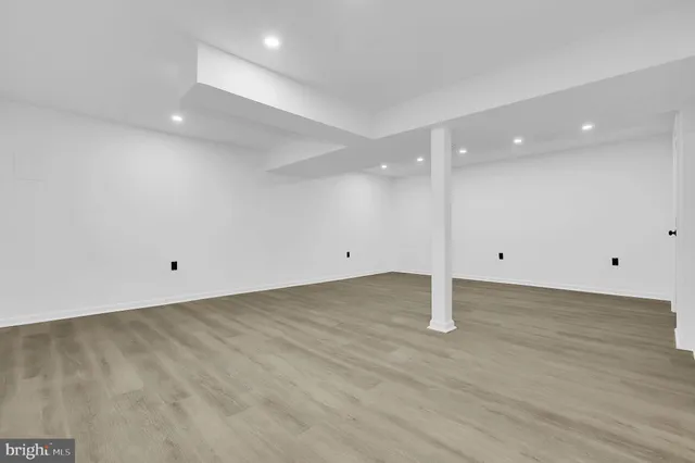 a view of a room with wooden floor