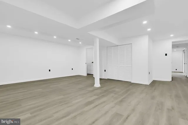 an empty room with wooden floor