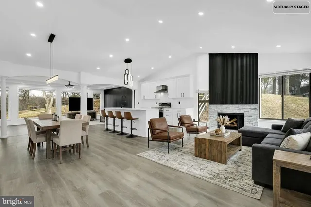 a living room with fireplace furniture and a flat screen tv