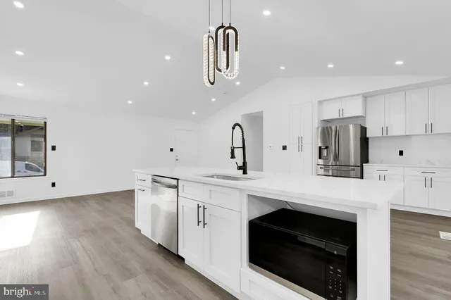 a kitchen with a sink stainless steel appliances and cabinets
