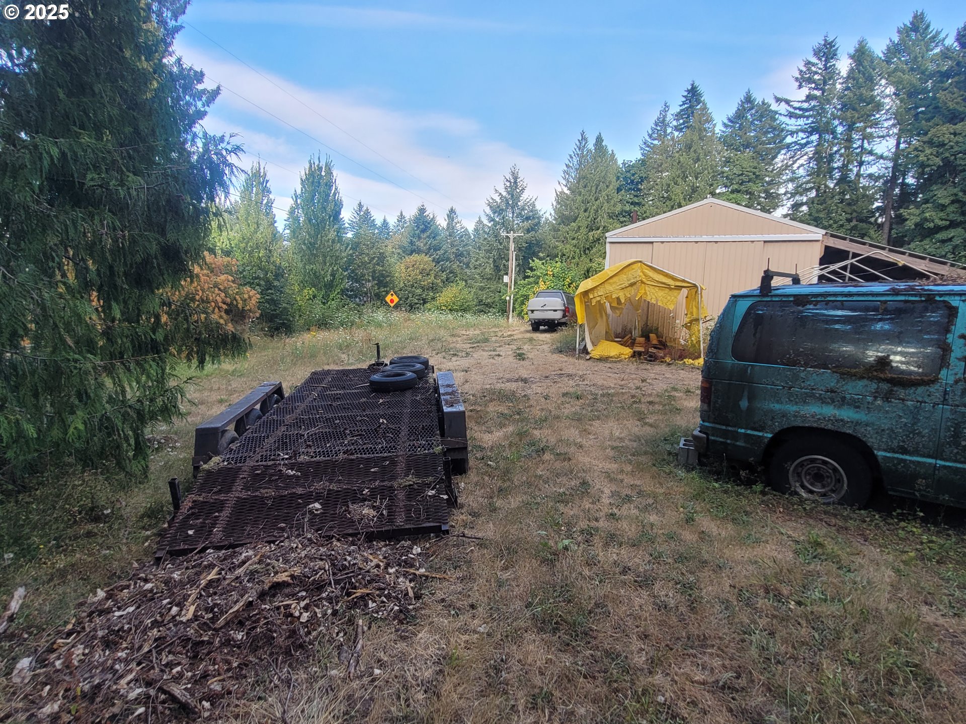 36160 Skogan Road Sandy, OR 97055 - Photo 26 of 35 a view of a house with truck parked on a road near a forest