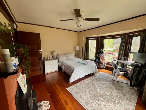 a bedroom with a bed a couch and dresser