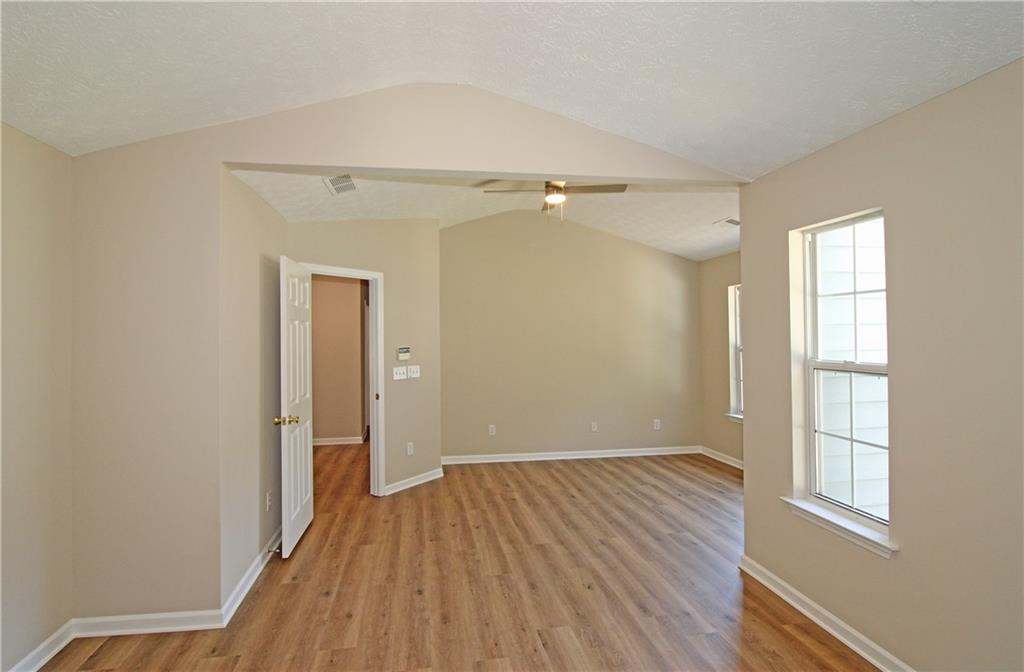 1334 Ambercrest Way Austell, GA 30168 - Photo 15 of 20 wooden floor in an empty room with a window