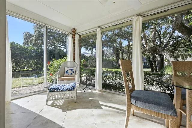 a living room with furniture and a floor to ceiling window