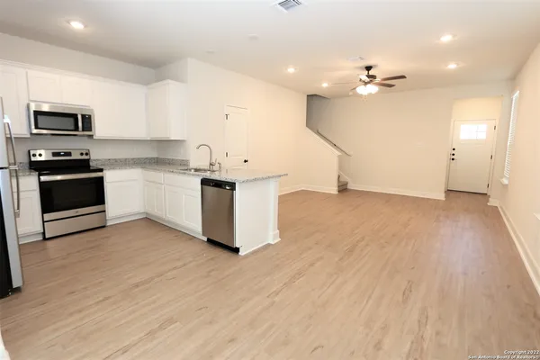 a kitchen with stainless steel appliances a stove top oven and sink