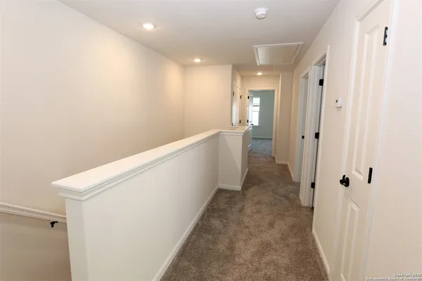 a view of a hallway with white walls