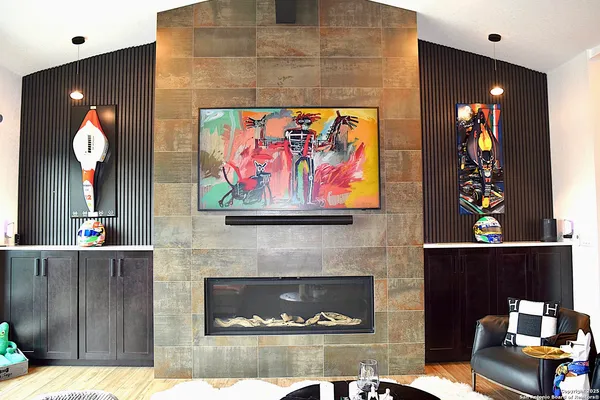 a living room with furniture and wooden floor