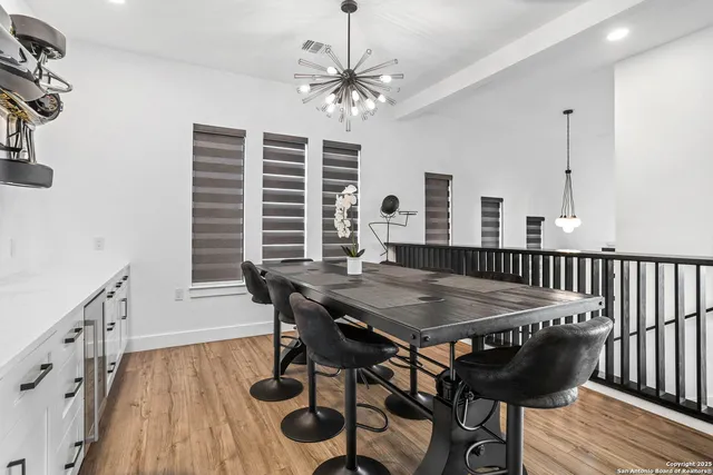 a view of a dining room with furniture and wooden floor