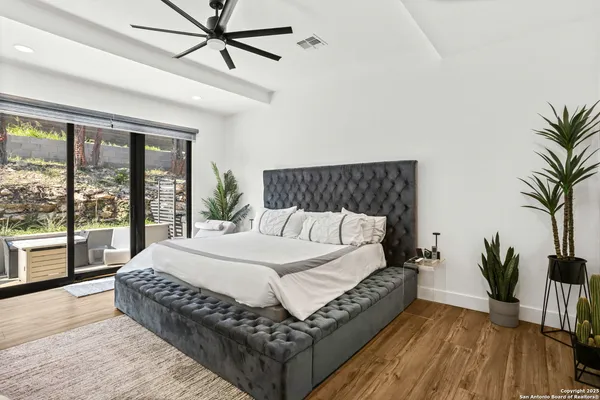 a bedroom with furniture and a large window