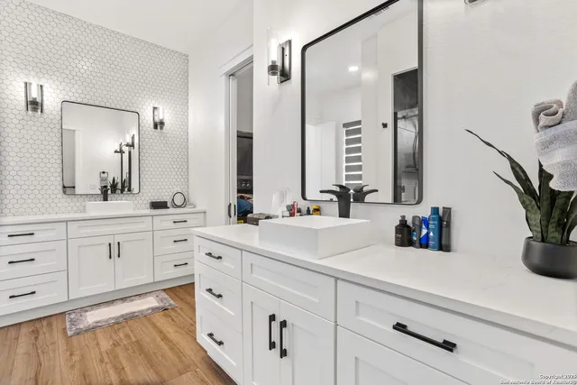 a spacious bathroom with a shower sink and a mirror