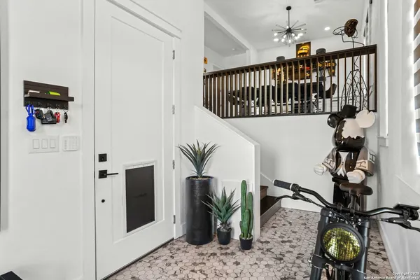 a kitchen with stainless steel appliances kitchen island granite countertop a table chairs and a refrigerator