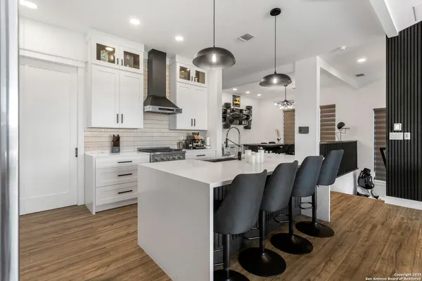 a large kitchen with stainless steel appliances kitchen island granite countertop a large island in the center