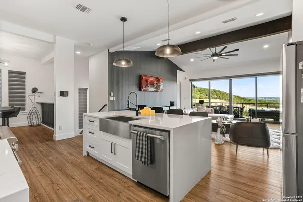 a living room with fireplace furniture and a large window