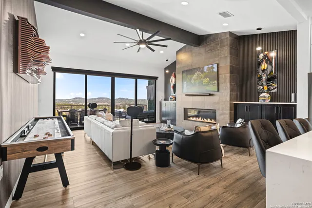 a living room with fireplace furniture and a flat screen tv