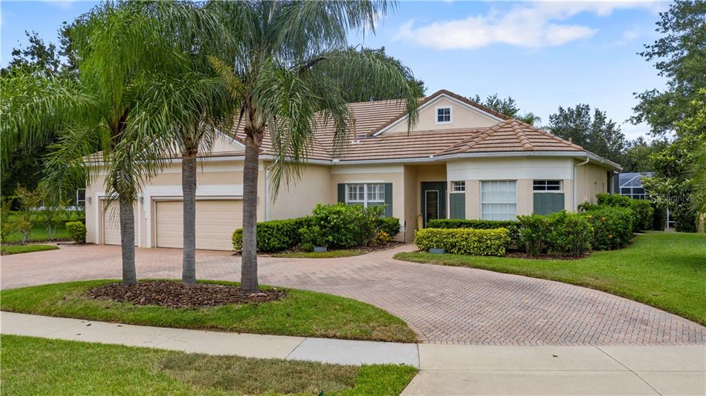 2792 Falcon Ridge Clermont, FL 34711 - Photo 1 of 1 a front view of a house with a garden and plants