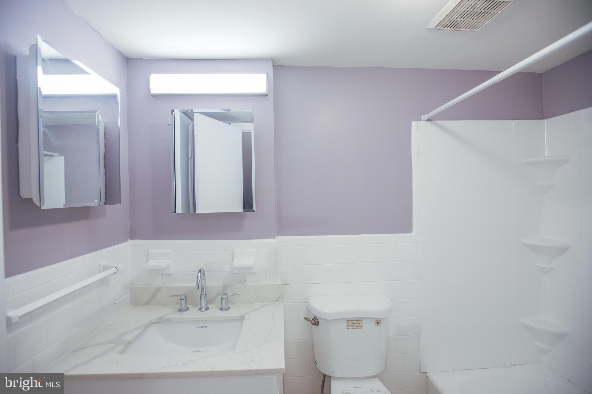 1705 Addison Road South District Heights, MD 20747 - Photo 2 of 26 a bathroom with a sink and a mirror